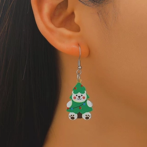 Close-up of a Christmas white bear earring in a green tree costume on a model ear