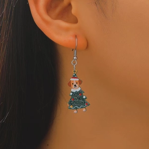 Close-up of a Christmas dog earring on a model ear, featuring a puppy in a festive tree outfit