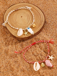 Detail view of handmade ocean beach style woven bracelets with sea star and shell charms