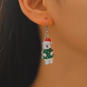 Detail of Christmas polar bear earring in green sweater worn by a model