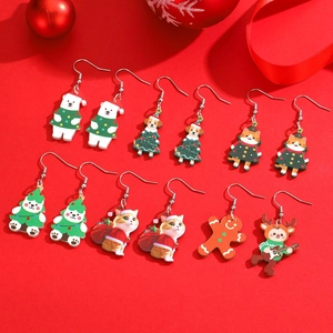 Christmas earrings set with festive animals and gingerbread man on red background