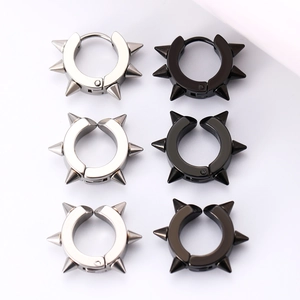 Close-up of punk style silver and black spike rivet hoop earrings in polished steel