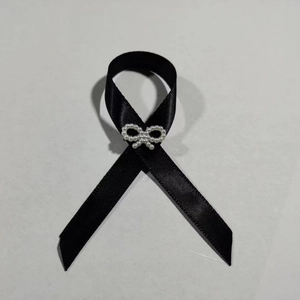 Black mourning awareness ribbon brooch with white pearl bow accent for funerals