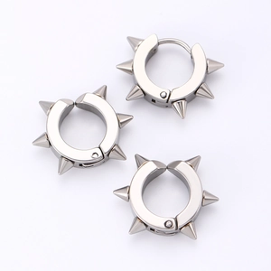 Detailed view of silver punk spike earrings with polished stainless steel texture