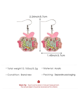 Macro detail of acrylic teacher apple earrings featuring leopard print and floral design