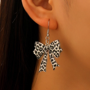Detail view of leopard print bow earrings featuring high-quality acrylic and fishhook wires