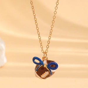 Detailansicht der Goldkette mit braunem Emaille-Football und blauem Schleifenanhänger