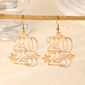 Macro detail of gold 2025 year number and star drop earrings on wooden branch