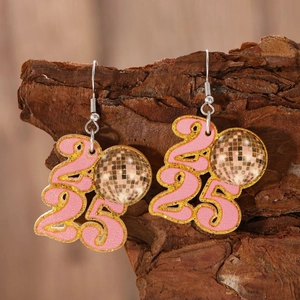 Detail of 2025 pink glitter disco ball earrings on a textured wooden tree bark backdrop