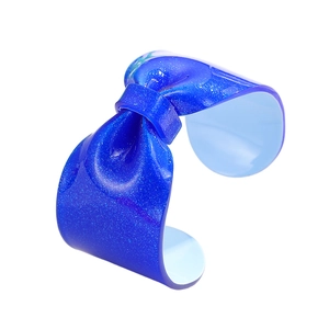 Macro detail of blue glitter resin open bangle with stylish 3D bow design