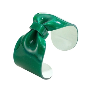 Detail shot of a dark green resin bow bangle with sparkling silver glitter finish