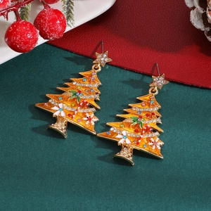 Close-up of Christmas tree earrings with colorful rhinestones and festive decor