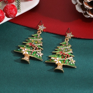 Close-up of festive Christmas tree earrings with colorful rhinestones and enamel details