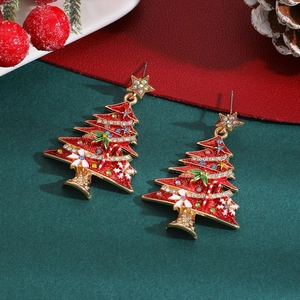 Detailed macro view of gold-plated Christmas tree earrings with colorful rhinestones