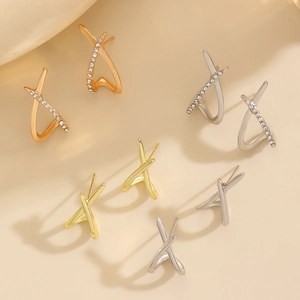 Detail view of stylish X-shaped crossover earrings with micro-pave white cubic zirconia