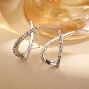 Close-up of silver-tone X-shaped hook earrings with sparkling cubic zirconia inlay