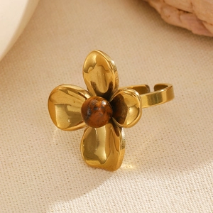 Close-up of golden flower ring with tiger eye stone and adjustable open band detail