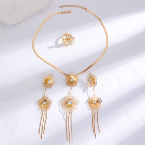 Detailed view of golden floral jewelry set with hollow petals and zircon stone inlays