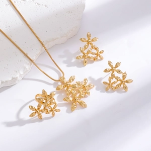 Detailed view of golden 3D flower jewelry set including necklace ring and earrings