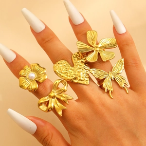Detailed view of 18k gold plated chunky rings set with floral and butterfly motifs
