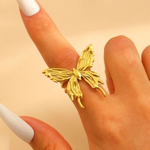 Macro shot of gold butterfly ring with hollow texture on 18k gold plated stainless steel