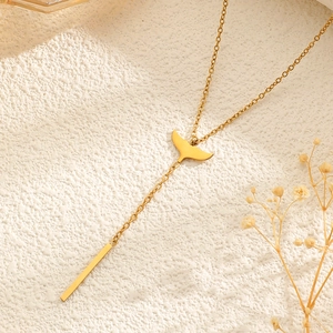 Macro detail of 18k gold plated stainless steel flower tassel necklace with light and shadow