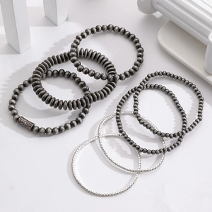 Close-up of set of 7 beaded bracelets with vintage metal beads and sparkling rhinestones