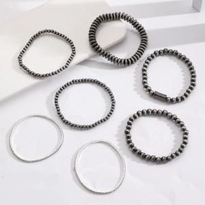 Detailed view of 7-piece silver beaded bracelet set with punk style textured metal beads