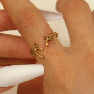 Detail shot of a stylish gold bow knot open ring with polished metal finish