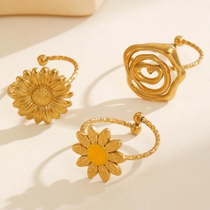 Detailed macro of gold flower ring set with daisy and rose motifs in open band style