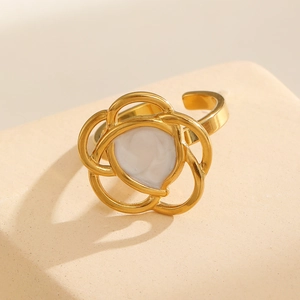 Detailed macro of 18k gold plated stainless steel open ring with pearly inlay flower