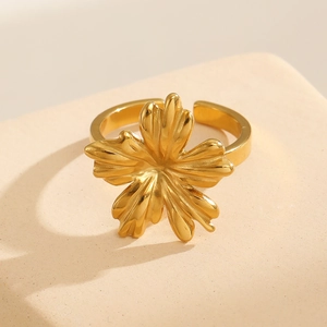 Macro detail of a 3D gold flower ring showing textured petals and 18k plated finish