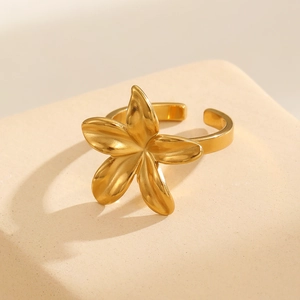 Macro detail of 18k gold plated stainless steel floral ring with polished petal surface