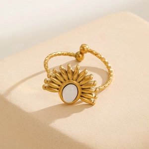 Macro view of gold plated open ring with white oval stone and sunburst hammered texture