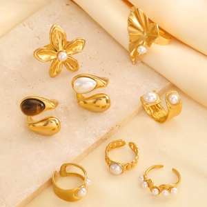 Collection of seven 18k gold plated stainless steel open rings with pearls and tiger eye stone