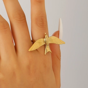 Detailed close-up of a 18k gold-plated stainless steel bird wing open ring on hand