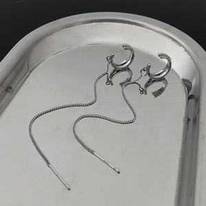 Detail of S925 sterling silver tassel ear cuff with C-shape zircon and long metal chains
