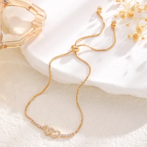 Detailed shot of interlocking hearts bracelet with rhinestones and adjustable slider