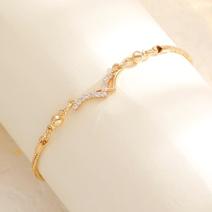 Detail of adjustable gold bracelet with shimmering V-shaped pavé diamond butterfly charm