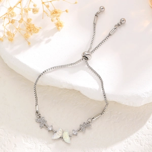 Detail of adjustable silver butterfly bracelet with iridescent shell and micro-set zircons