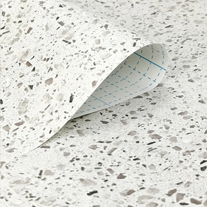 Close-up of terrazzo wallpaper with blue grid backing for easy cutting and self-adhesion