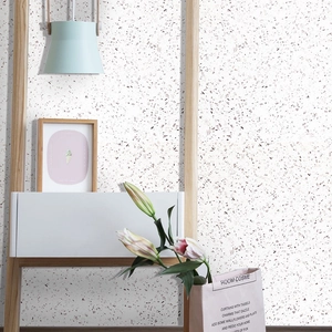 Self-adhesive white terrazzo wallpaper with pink and grey fragments in Nordic home setting