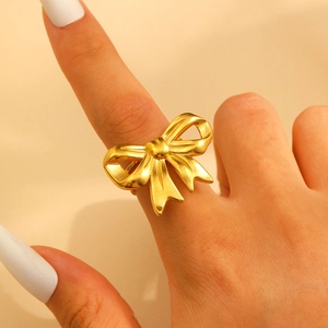 Exaggerated 18k gold plated stainless steel ring with 3D bow tie design on index finger