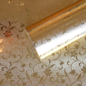 Detail of gold floral embossed PET kitchen wallpaper with textured foil metallic finish