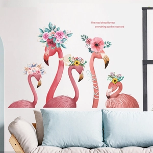 Pink flamingo wall decals with floral crowns and inspirational quote on white wall