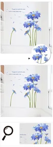 Close-up of blue daisy wall stickers with poetic quote and petal details on white wall