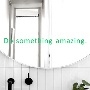 Glow-in-the-dark 'Do something amazing' wall sticker on bathroom mirror