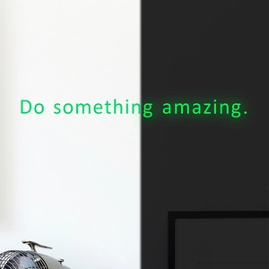 Glow-in-the-dark wall decal with Do Something Amazing inspirational text in green light