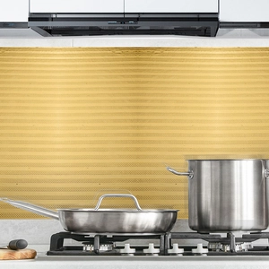 Close-up of golden brushed kitchen wall sticker with linear texture for oil-proof decor