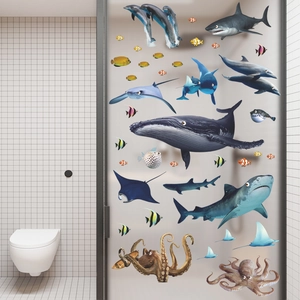 Vibrant sea creature wall decals featuring whales and sharks on a bathroom glass door